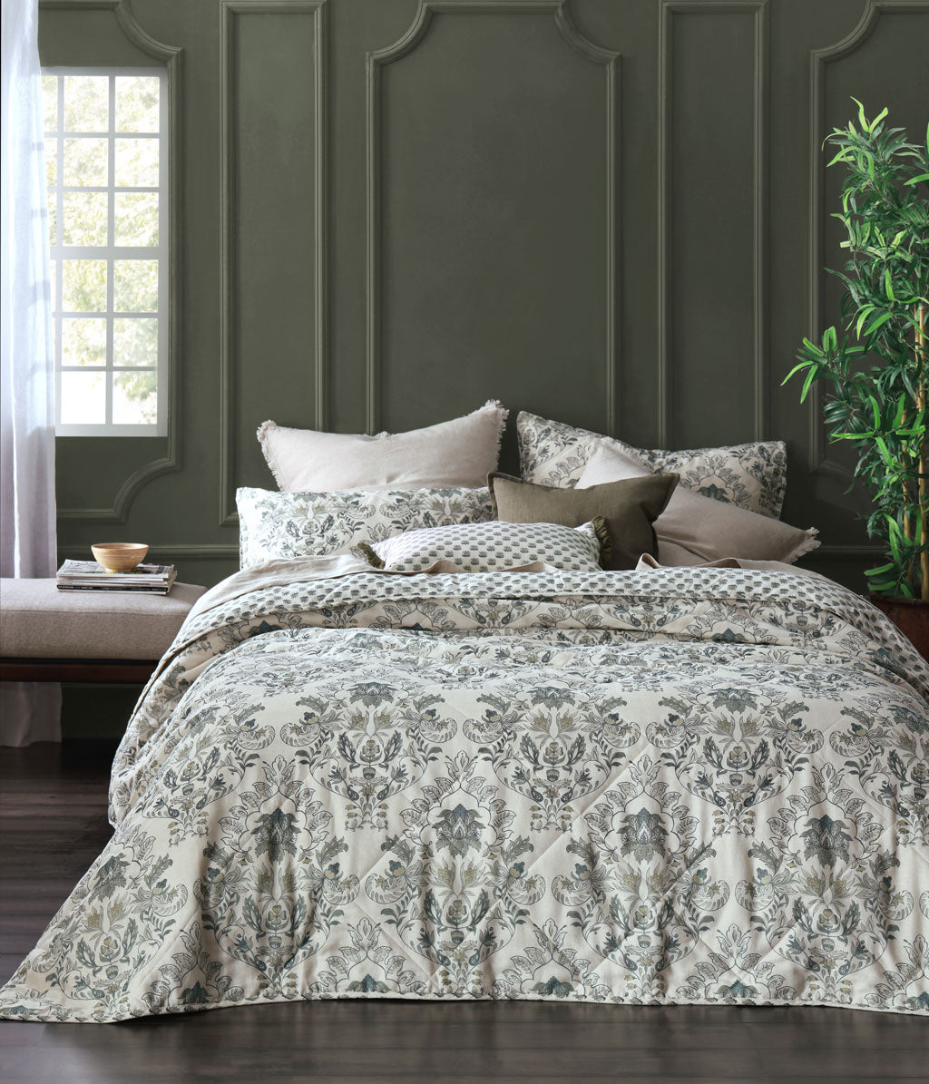 Mediterranean inspired with a classic and earthy charm. This design echoes a rococo elegance reimagined in neutral and olive tones amongst a European flax linen ivory base.